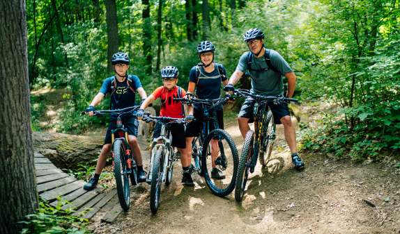 Family of four on mountain bikes on DTE Energy Foundation Trail