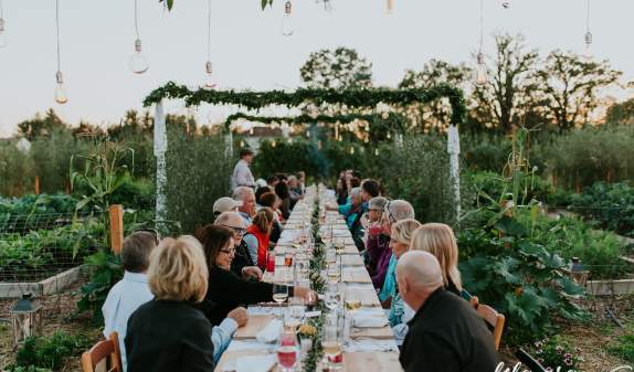 Group having an outdoor dinner in a garden at Cornman