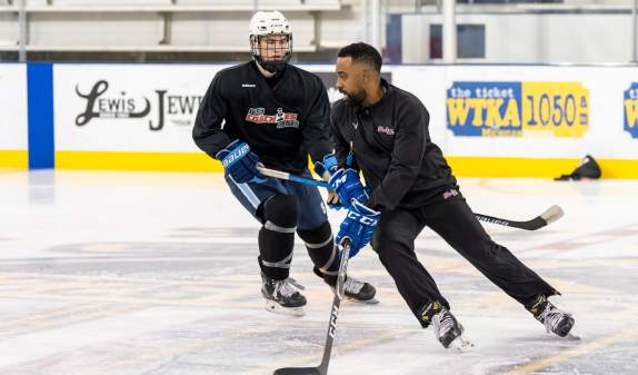 Hockey player and hockey coach on the ice