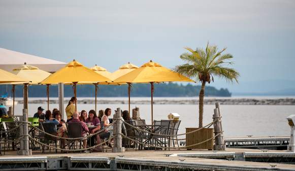 yellow umbrellas and outdoor dining on the edge of Lake Champlain