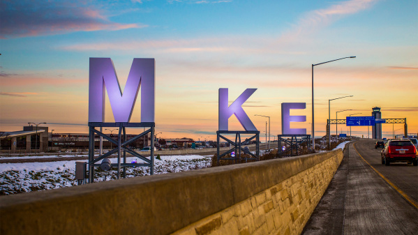 big MKE letters by airport, sunrise