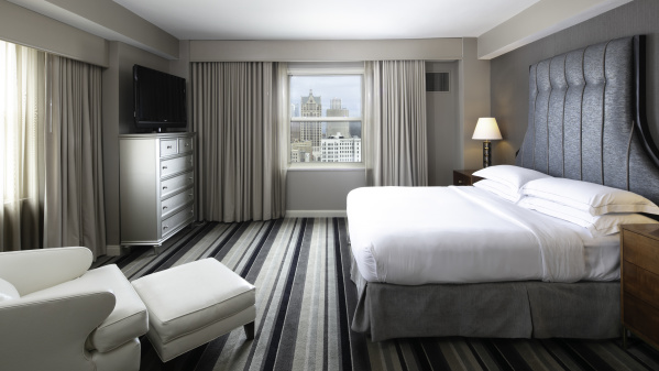 interior of a hotel room with Milwaukee Skyline prominent outside the window