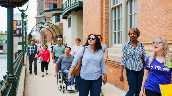 tour group walks down riverwalk