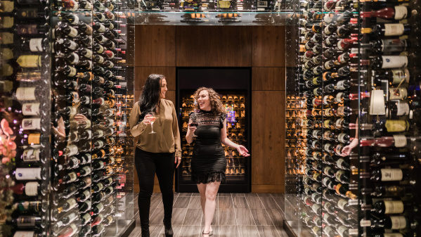 two women with wine walking in "wine tunnel"