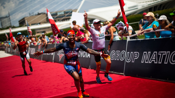 triathlete crossing the finish line in front of the Milwaukee Art Museum at the 2022 USA Triathalon