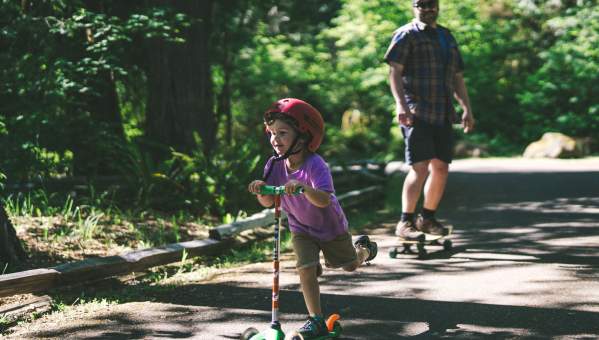 A kid riding a scooter