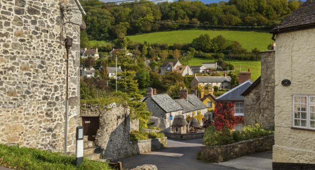 A street in Branscombe surrounded by fields and blue sky