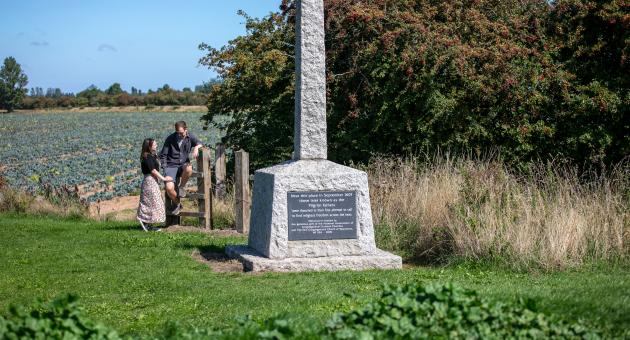 Two people admiring a memorial statue