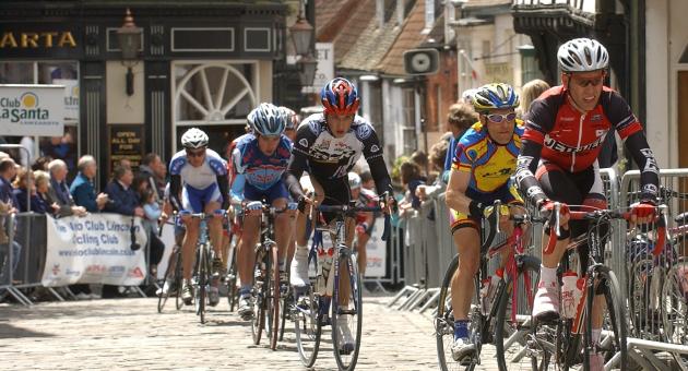 Group of cyclists racing through Lincoln streets