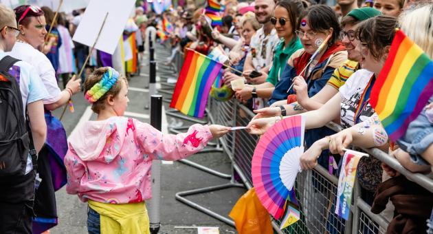 People walking on a pride parade route
