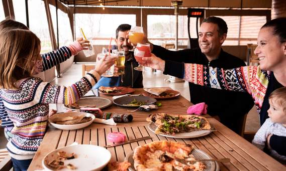 Family cheers-ing while dining and drinking at Meier's Creek Brewing Company in Cazenovia, NY