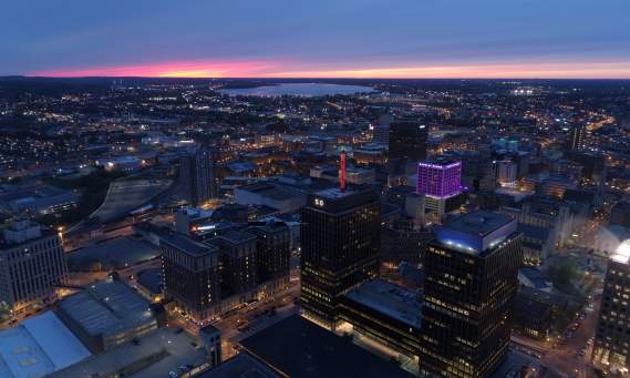 Skyline of Syracuse showing downtown and lake at dusk