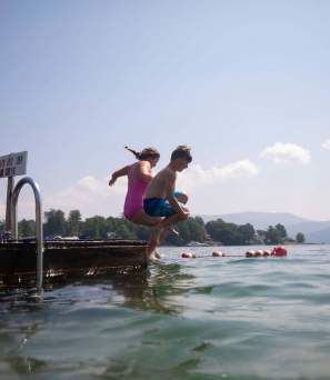 Kids jumping off a dock at Rogers Memorial Park