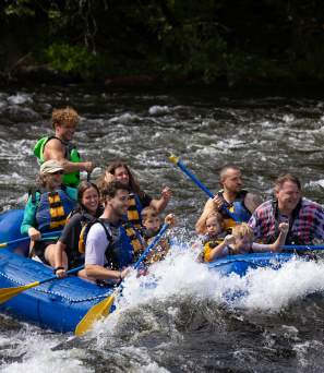 A group whitewater rafting with Adirondack Adventure Center