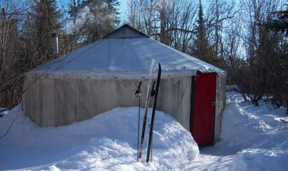 Skis outside of yurt in winter on the banadad ski trail