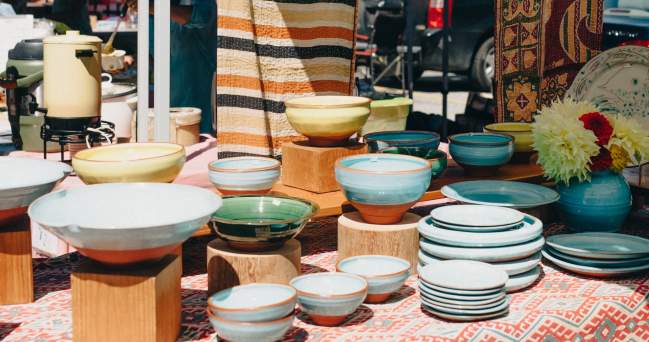 A table full of colourful bowls and plates.