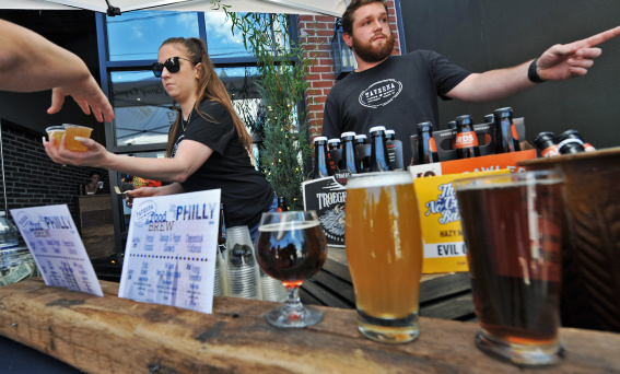 Bartenders serving beer at the Downtown Newark Food + Brew Festival