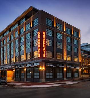 Outside of the Graduate Hotel at dusk