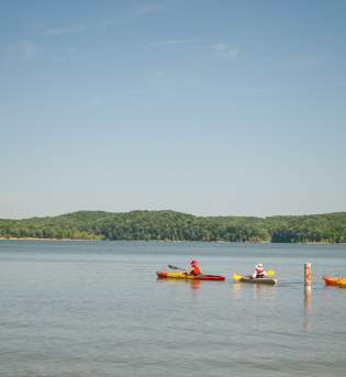 Four people kayaking on Monroe Lake