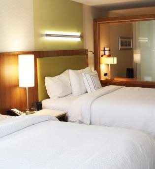 Two-queen hotel room in Bloomington
