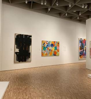 A few pieces of artwork in a gallery at the Eskenazi Museum of Art