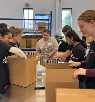 A group of volunteers packaging boxes at the Food Bank for the Heartland.