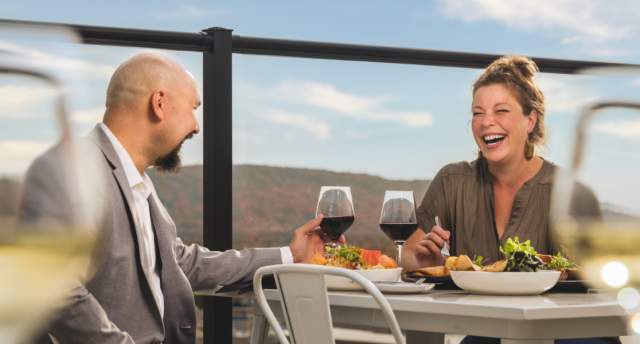 With Rib Mountain in the background, a couple dines at the rooftop restaurant, The Velveteen Plum