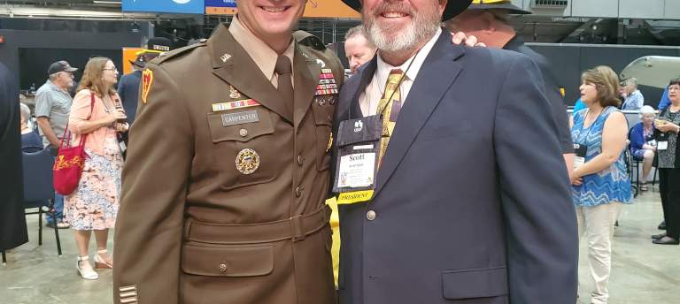 two men in military uniforms at a military reunion event