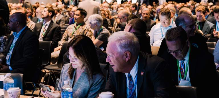 a group of people at a business or government conference meeting