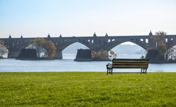 a bench placed right next to the beautiful riverbank of the Susquehanna