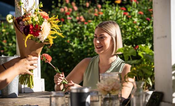 a customer purchasing beautiful flowers at Terra Farms