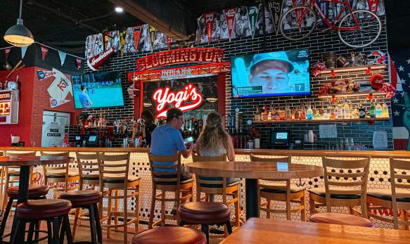 A couple sitting at the bar at Yogi's