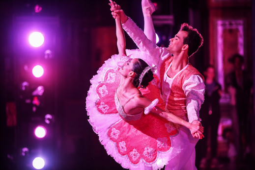 male and female performer pose on stage