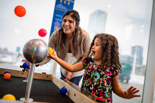 mom and daughter interacting with objects