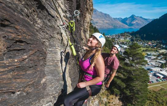 Two people rock climbing above Queenstown with Via Ferrata