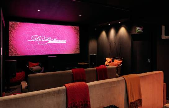 Inside of a boutique cinema with couches and blankets