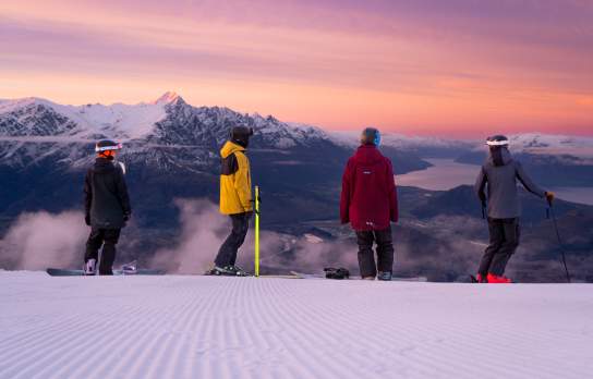 Skiers watching the sunrise at Coronet Peak
