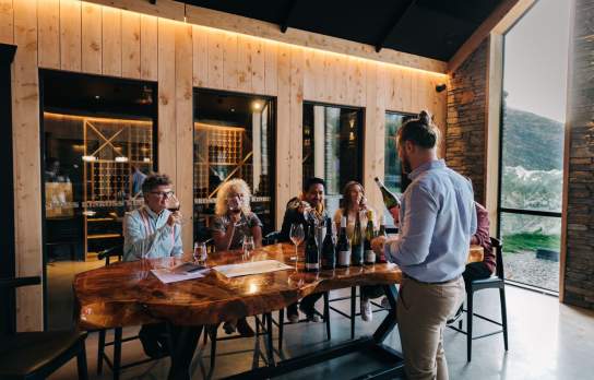 A group of people attending a wine tasting at Kinross in Gibbston near Queesntown
