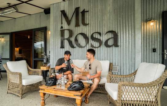 Two men sat at a table tasting wines at Mt Rosa winery