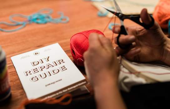 A group of passionate friends repair their beloved Patagonia clothing instore