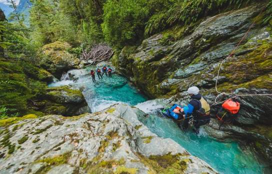 Canyoning the Routeburn, getting ready to slide.