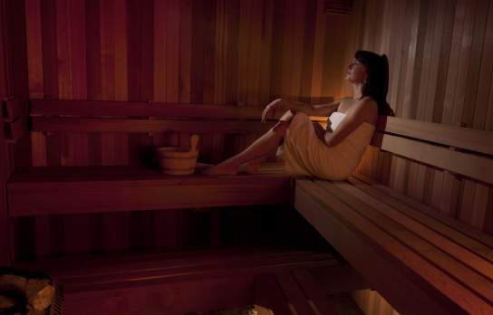 A lady enjoys a relaxing sauna at eforea Spa Hilton Queenstown