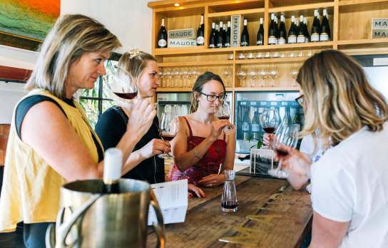 A group of ladies enjoying a wine tasting at Maude Wines in Wānaka