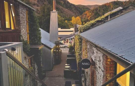 Alleyway view of Arrowtown shops at sunset