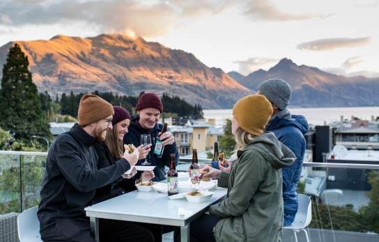 Friends enjoying cold beverages o the balcony at mi-pad