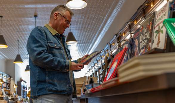 Man looking at book in bookshop