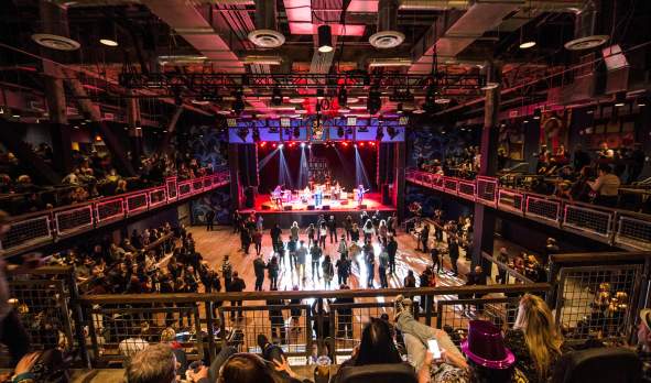 Band performing onstage at a crowded House of Blues Anaheim, CA.