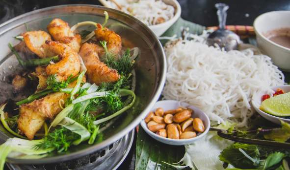 Turmeric and dill fish with herbs, rice noodles and dipping sauce at Hanoi Corner in Anaheim, CA.