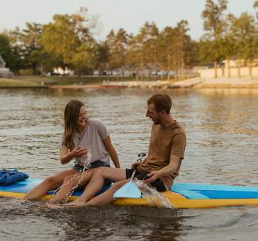 Couple having fun on paddleboards from Kiki's Paddleboards at Lake Sara