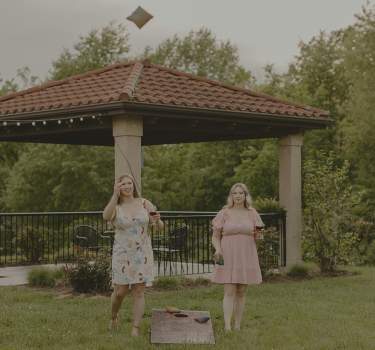 Two women playing bags at Tuscan Hills Winery with Overlay